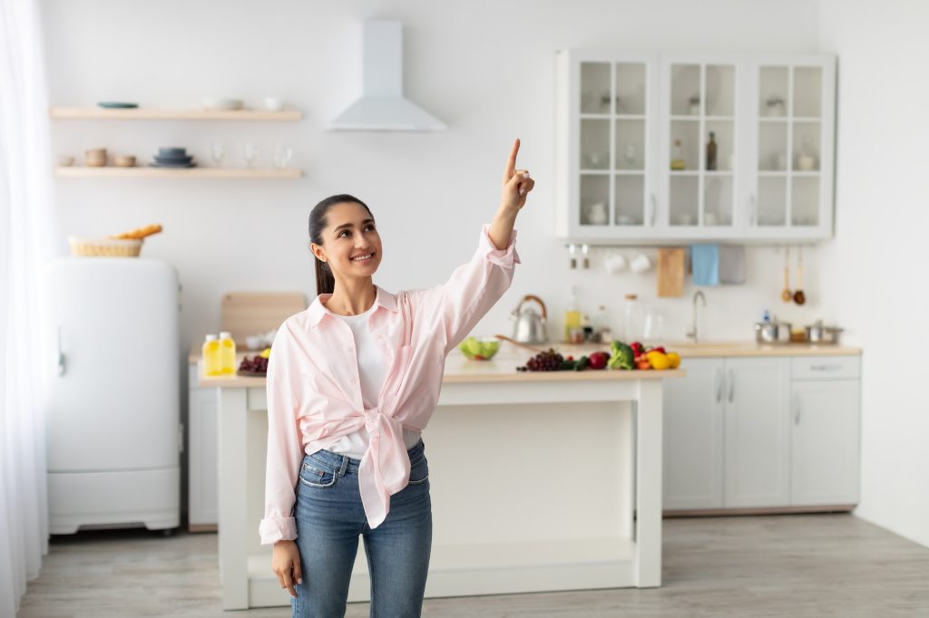 Smart Home Concept. Millennial Woman Pointing Finger Up